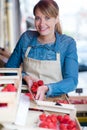 Female grocer unpacking crates strawberries