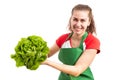 Female grocery or retail shop employee presenting green lettuce