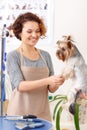 Female groomer starts to work on her pet client
