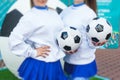 Female group of cheerleader in action, wearing white blue uniform with audience in the background performing and supporting during Royalty Free Stock Photo