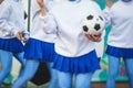 Female group of cheerleader in action, wearing white blue uniform with audience in the background performing and supporting during Royalty Free Stock Photo