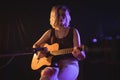 Female guitarist performing in music concert Royalty Free Stock Photo