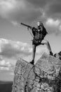 Female with a gun. Woman hunter with a gun. Calibers of hunting rifles. Hunter with a shotgun in a traditional shooting Royalty Free Stock Photo