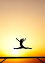 Female gymnast on balance beam in sunset Royalty Free Stock Photo