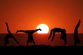 Female gymnast on beach in sunset