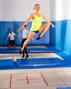 Female gymnast jumping on trampoline