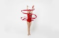 Female gymnast with red ribbon in motion on white background Royalty Free Stock Photo