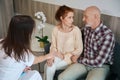 Female gynecologist reassuring anxious future parents at medical clinic Royalty Free Stock Photo