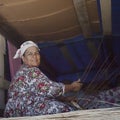 Female gypsy weaving handmade baskets. Editorial