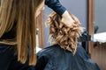 Female hairdresser chacking woman`s hairstyle Royalty Free Stock Photo