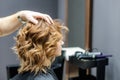 Female hairdresser checking woman`s hairstyle