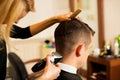 Female hairdresser cutting hair of smiling man client at beauty Royalty Free Stock Photo
