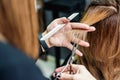 Female hairdresser is cutting woman hair close up Royalty Free Stock Photo