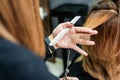 Female hairdresser is cutting woman hair close up Royalty Free Stock Photo