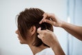 Female hairdresser making hairstyle to brunette girl in beauty salon. Royalty Free Stock Photo