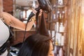 Female hairdresser making hairstyle to girl in beauty salon. Royalty Free Stock Photo