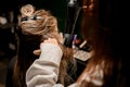 Female hairdresser stylist skilfully making hairstyle using hair dryer and round comb Royalty Free Stock Photo