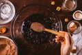 Female hand adding spoonful of cocoa powder Royalty Free Stock Photo