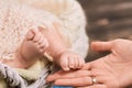 Female hand and baby feet. Royalty Free Stock Photo