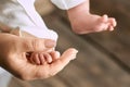Female hand and baby foot. Royalty Free Stock Photo