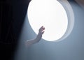 Female hand on the background of a round window in the rays of sunlight Royalty Free Stock Photo