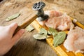 Female hand beat chicken fillet with hammer Royalty Free Stock Photo