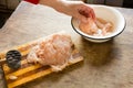 Female hand beat chicken fillet with hammer Royalty Free Stock Photo