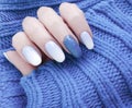 Female hand beautiful fashion blue manicure, sweater, winter style Royalty Free Stock Photo