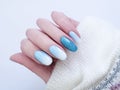 Female hand beautiful fashion design stylish ombre acrylic manicure, sweater, winter Royalty Free Stock Photo