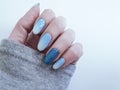 Female hand beautiful fashion blue design ombre manicure, sweater, winter style Royalty Free Stock Photo