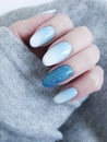 Female hand beautiful fashion blue ombre manicure, sweater, winter style Royalty Free Stock Photo