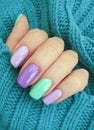 Female hand beautiful manicure colored sweater elegant