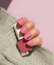 Female hand beautiful pink shellac fashionable manicure sweater creative