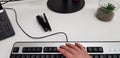 Female hand on black computer keyboard