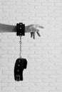 Female hand in black handcuffs for sex games