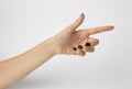 Female hand with black nails, gesturing ok. on white background.