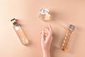 Female hand and bottles of perfume on color background Royalty Free Stock Photo