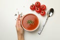 Female hand and bowl of tasty tomato soup, top view Royalty Free Stock Photo