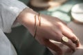 female hand with brass Copper bracelet and gold vintage stylish polished ring