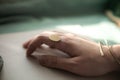 female hand with brass Copper bracelet and gold vintage stylish polished ring