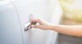 Female hand of a business woman with a pushing open botton of the car door Royalty Free Stock Photo