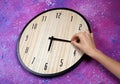 Female hand change time on big clock Royalty Free Stock Photo