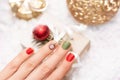 Female hand with Christmas nail design with nails art. Glitter Christmas nail polish manicure: red and green Royalty Free Stock Photo