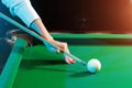 Female hand close-up, billiards, player preparing to hit the ball. Pleasant pastime, entertainment, leisure, family holidays, Royalty Free Stock Photo