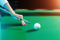 Female hand close-up, billiards, player preparing to hit the ball. Pleasant pastime, entertainment, leisure, family holidays, Royalty Free Stock Photo