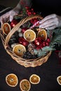 Female hand collects a wicker basket with Christmas decorations and goods as a gift Royalty Free Stock Photo