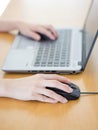 Female hand with computer mouse on table, closeup Royalty Free Stock Photo