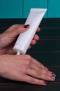 Female hand cream squeeze out of tube Royalty Free Stock Photo