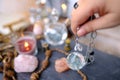 female hand with crystal glass ball, pendulum swings over astrologer's table, Harmony with meditation, self-discovery