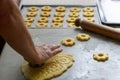 Female hand cutting biscuits from the dough Royalty Free Stock Photo